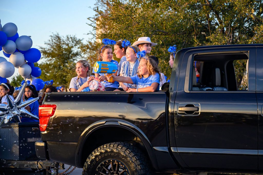The Cox Elementary PTA float and Comet families in the Vista Ridge homecoming parade