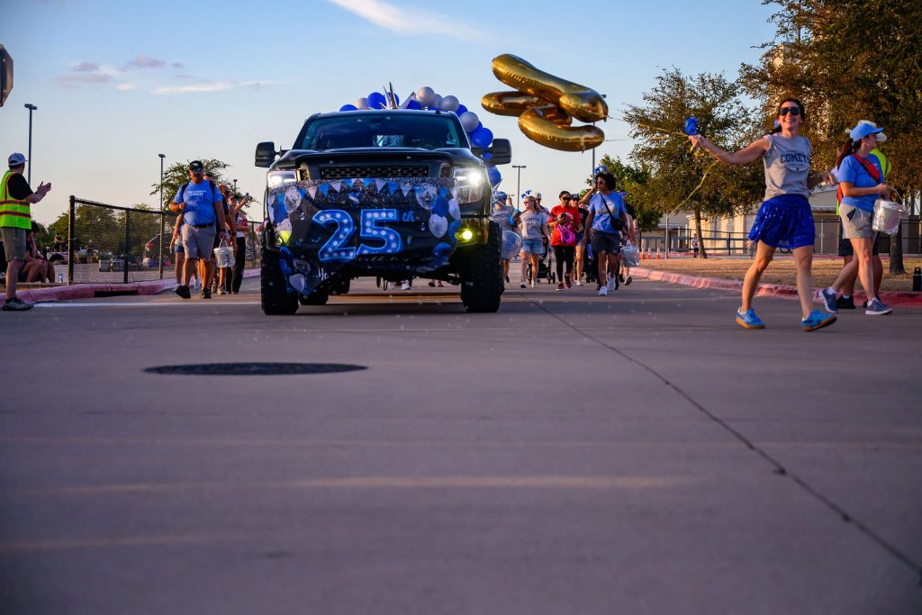 The Cox Elementary PTA float and Comet families in the Vista Ridge homecoming parade